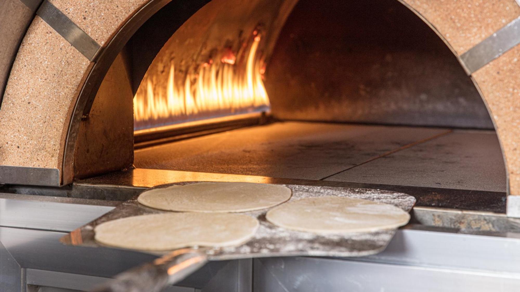 The Abdali Boulevard Hotel Амман Екстер'єр фото Pizza dough in a wood-fired oven